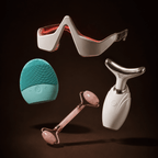 Four skincare tools on a dark background