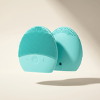 Turquoise silicone face cleansing brush on a beige background
