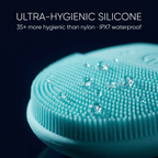 Turquoise silicone cleaning brush with water droplets on a black background, highlighting its hygienic properties.