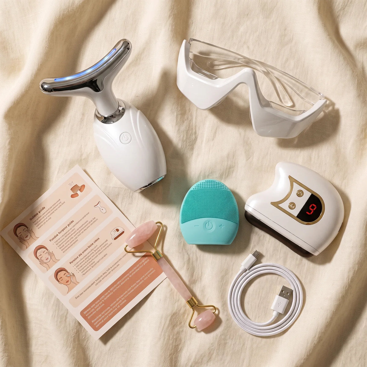 Everything in the box laid out on linen: the Contour Wand, the Halo, the cleanse brush, the roller, a charging cable and a printed guide.